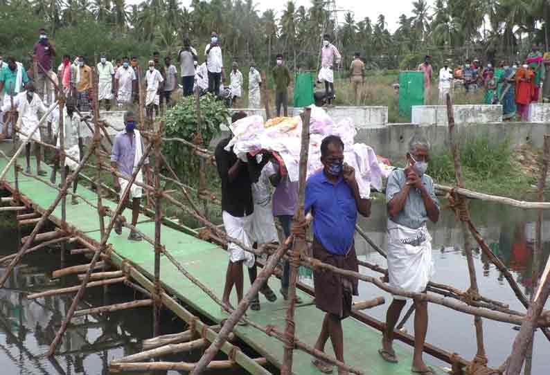 கோபி அருகே மயானத்துக்கு செல்ல பாதை இல்லாததால் ஓடையின் குறுக்கே தற்காலிக பாலம் அமைத்து உடலை கொண்டு சென்ற கிராமமக்கள்